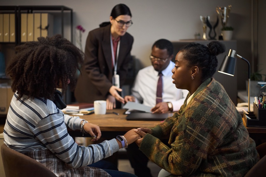 A guardian supporting a student during a meeting at school