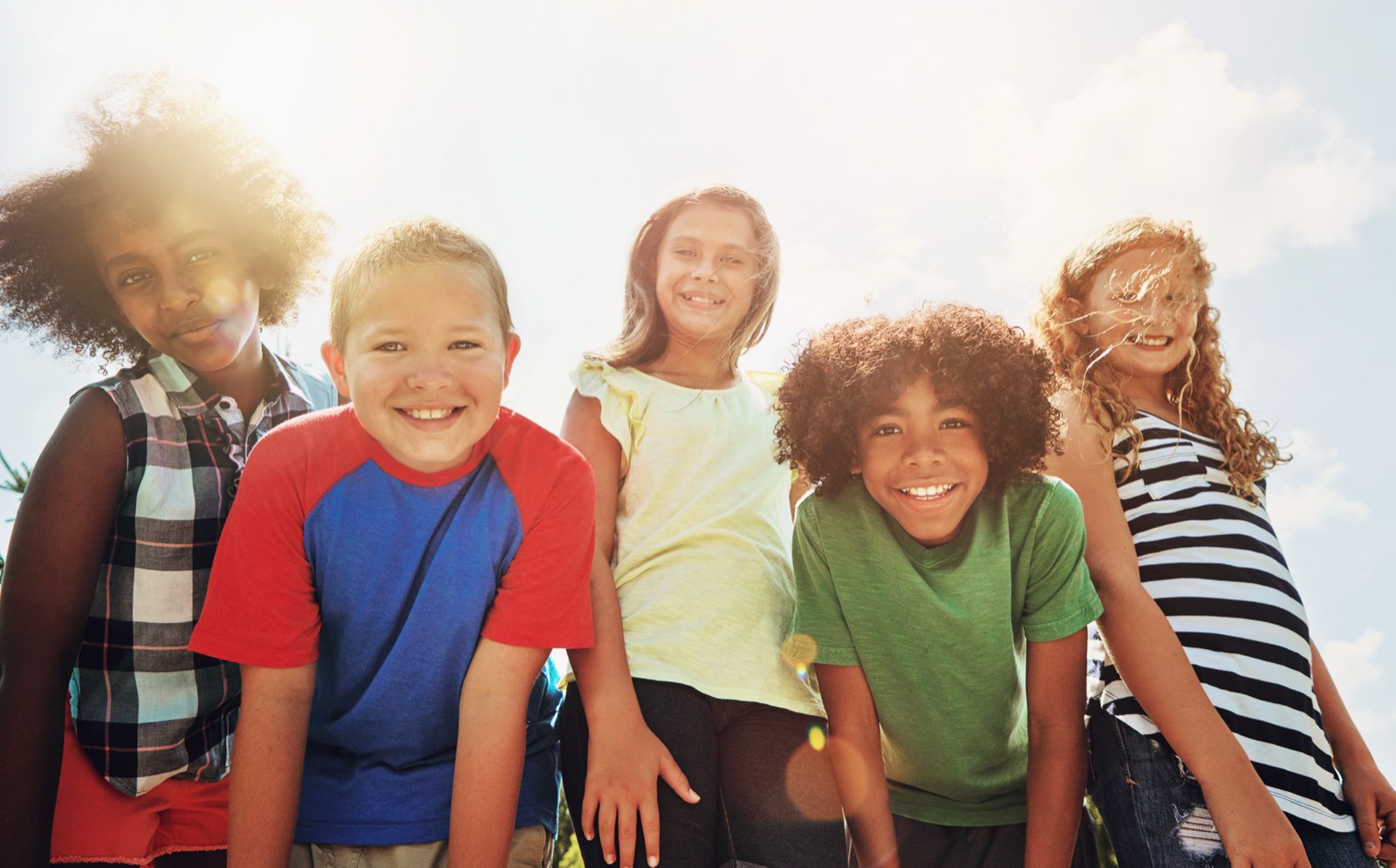 A group of smiling students standing together outdoors